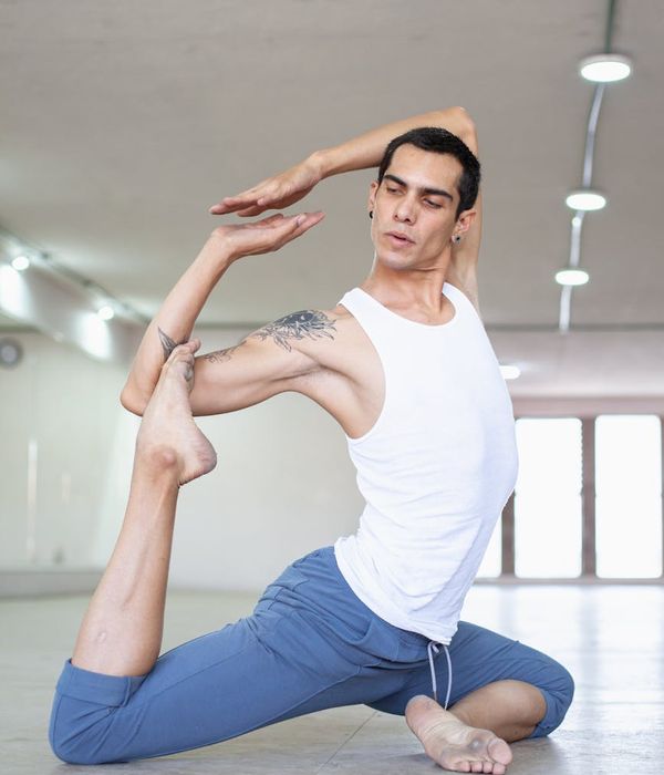 Man in a controlled strength pose with celestial blue light accents.